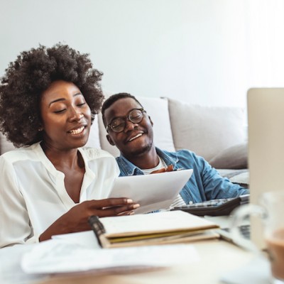 Couple Working On Taxes On Couch