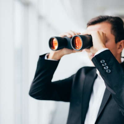Man Using Binoculars In Suit