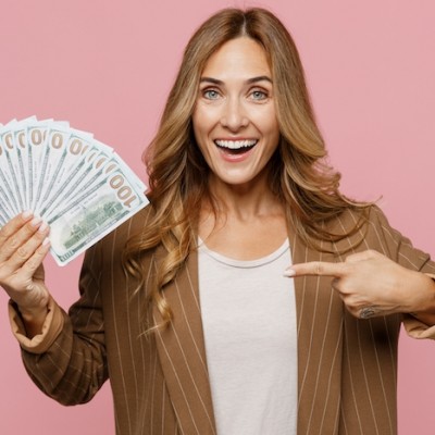 Woman Holding Money Pink Background