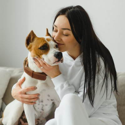 Young Girl Cuddles Dog