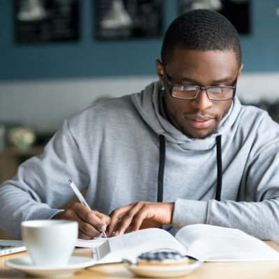 Young Man Writing Notes