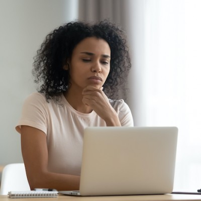 Young Woman Confused At Laptop